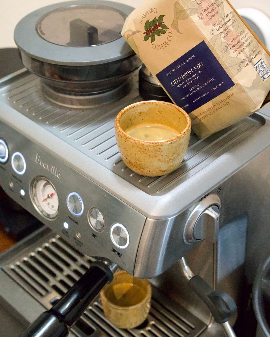 Handmade espresso and latte cups paired with Salvadoran coffee beans