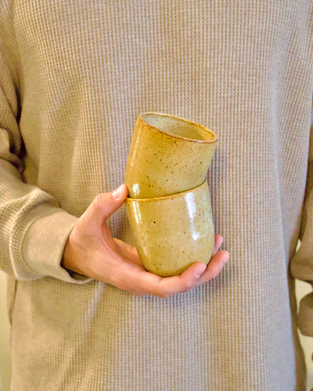 Handmade ceramic cups with a bag of Navarro Coffee Co. Salvadoran coffee